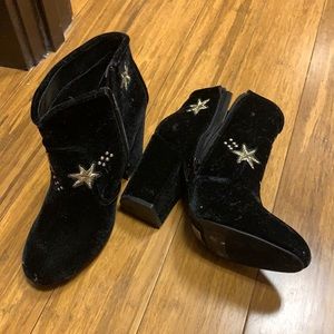 Black velvet boots with embroidered gold stars.